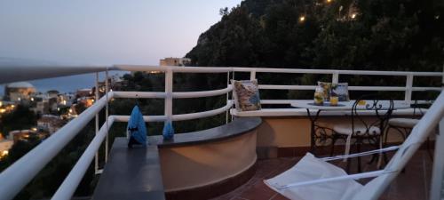 a balcony with a table and a view of a city at Cielo e Mare in Positano