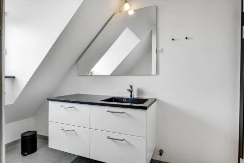 a bathroom with a sink and a mirror at BV284-Blavand-Blavand-Strand-4 in Blåvand
