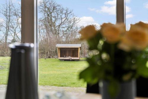 a vase of flowers sitting in front of a window at BV302-Blavand-Gronnevej-12 in Blåvand