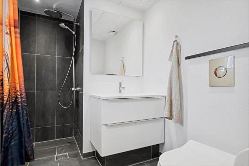 a bathroom with a white sink and a shower at BV302-Blavand-Gronnevej-12 in Blåvand