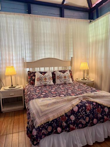 a bedroom with a large bed with two night stands at Campito Loving in Higuey