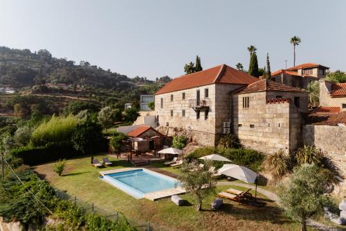 an external view of a house with a swimming pool at MONTD'OR Azenha - by RowdHouses in Paços de Gaiolo
