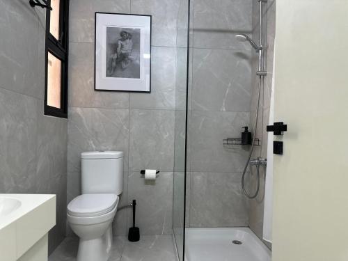 a bathroom with a toilet and a glass shower at Modern City Apartment in Larnaka