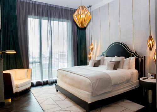 a bedroom with a large bed and a chair at Hotel Indigo Los Angeles Downtown in Los Angeles