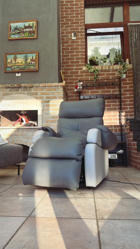 a group of chairs sitting in front of a fireplace at Tubize in Tubize