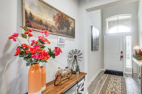 a room with a vase of flowers on a table at Spacious Family Home with Office in Midland-Odessa! in Midland