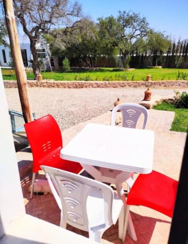a white table and four chairs on a patio at Villa Bouzama in Essaouira