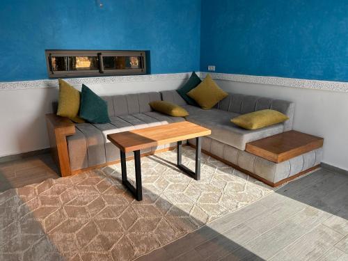a living room with a couch and a table at Villa Bouzama in Essaouira