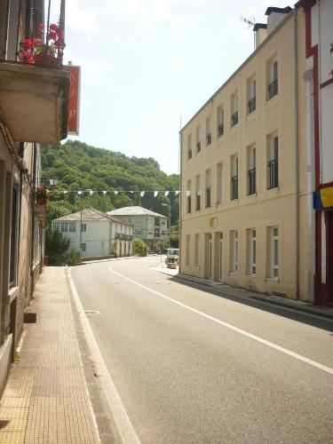an empty street in a town with buildings at Pensión Santa Rosa in Samos
