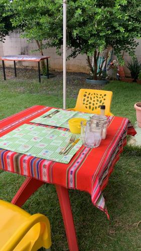 a picnic table with a colorful table cloth on it at Calmo e aconchegante apartamento térreo com quintal in Valparaíso de Goiás