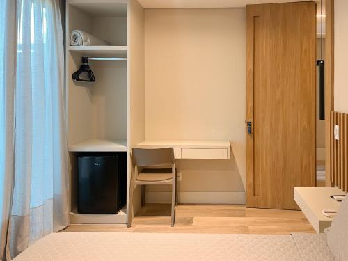 a small room with a desk and a tv at Marino Beach Hotel in Cabo Frio
