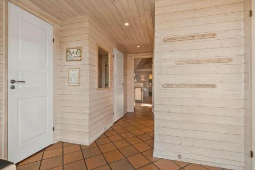 a hallway with a white door in a house at BV151-Blavand-Hedetoftvej-116 in Blåvand