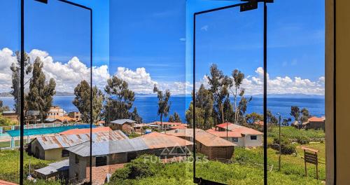 a room with a view of a city and the ocean at Amantani sol Andino in Amantani
