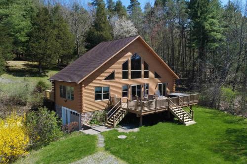 a log cabin with a porch and a deck at Hilltop on Keuka 