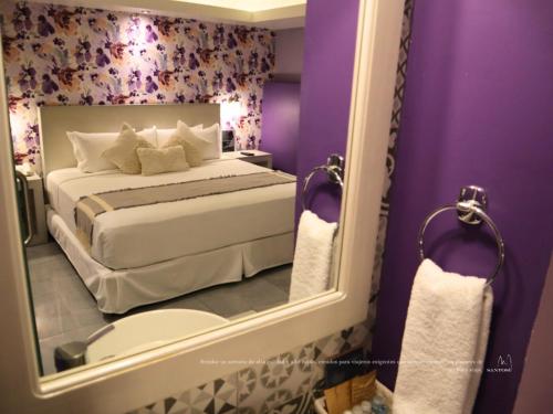 Ένα ή περισσότερα κρεβάτια σε δωμάτιο στο Hotel Santosi