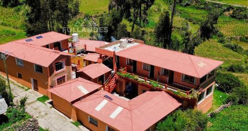 an overhead view of a house with a red roof at Amantani sol Andino in Amantani
