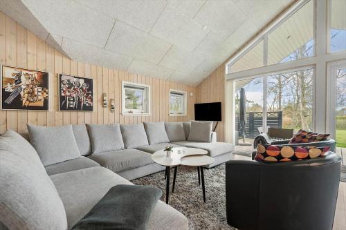 a living room with a couch and a table at BV313-Blavand-Hvidbjerg-Strandvej-40 in Blåvand