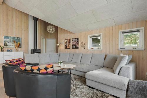 a living room with a couch and a table at BV313-Blavand-Hvidbjerg-Strandvej-40 in Blåvand