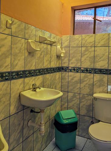 a bathroom with a sink and a toilet at Amantani sol Andino in Amantani