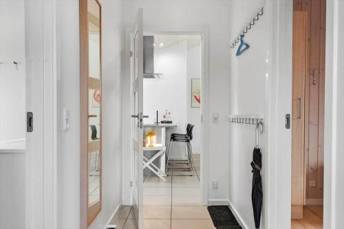 a hallway with a door leading to a dining room at BV269-Blavand-Hvidbjerg-Strandvej-25-A in Blåvand