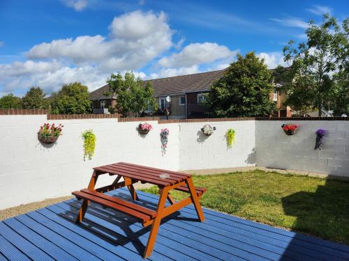 a wooden picnic table sitting on a deck at Lovely Private Room in Dublin