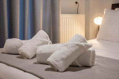 two towels on a bed in a hotel room at The Circle Point Apartment in Larisa
