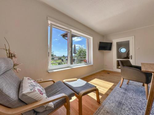 a living room with a couch and a window at Hochfels in Stadlern