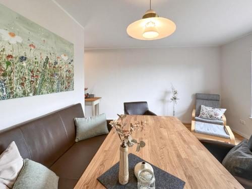 a living room with a wooden table and chairs at Hochfels in Stadlern