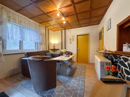 a living room with a couch and a table at Knusperhäuschen in Waldau