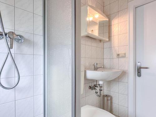 a white bathroom with a sink and a shower at Hochfels in Stadlern