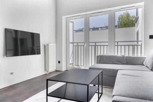a living room with a couch and a coffee table at Sea Loft 49 in Gdynia