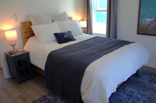 a bedroom with a large bed with white sheets and pillows at 1st Row, Unobstructed Gulf Views, Pet-Friendly! in Freeport