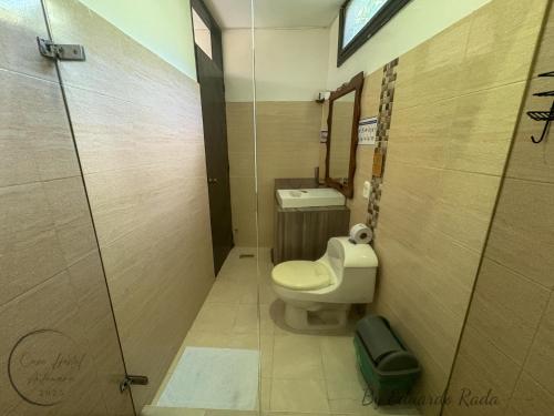 a bathroom with a toilet and a sink at Hostal Antawara Tayrona in El Zaino