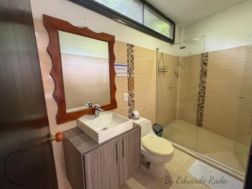 a bathroom with a sink and a toilet and a shower at Hostal Antawara Tayrona in El Zaino