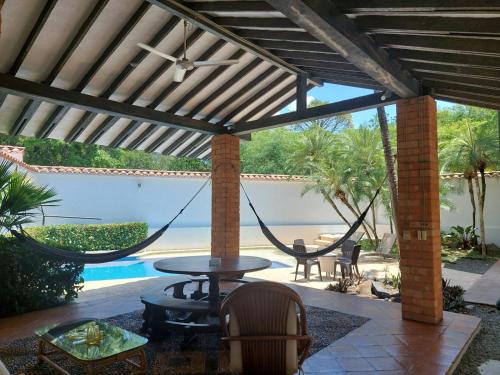a patio with a hammock and a pool at Espectacular Casa en Cauca viejo con piscina, jacuzzi y turco in Jericó