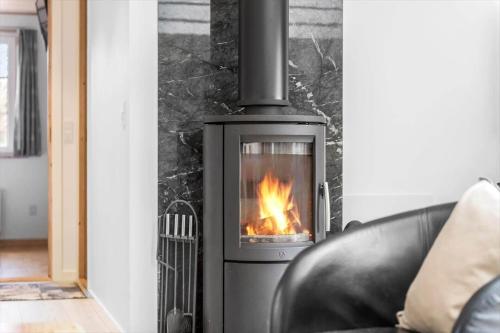 a stove with a fire in a living room at BV276-Blavand-Sonder-Vasevej-150 in Blåvand