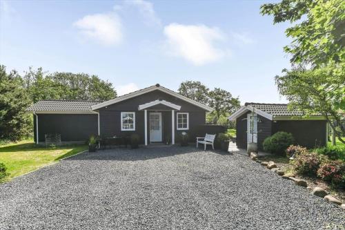 a house with a gravel driveway in front of it at BV276-Blavand-Sonder-Vasevej-150 in Blåvand