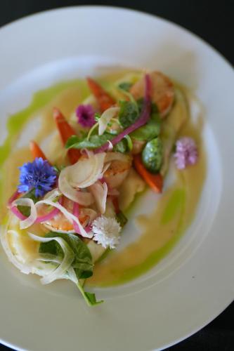 a white plate of food with vegetables on it at University Club of San Francisco in San Francisco