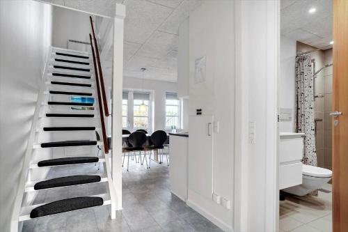 a white bathroom with a staircase with black accents at 0440-Romo-Vestergade-227-Ap-17 in Sønderby