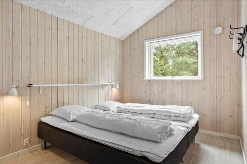 twee bedden in een kamer met een raam bij 0200-Romo-Elmegardsvej-10 in Tagholm