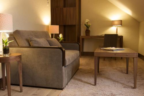 a living room with a couch and a table at Gran Hotel Balneario De Puente Viesgo in Puente Viesgo