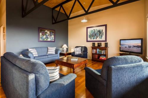 a living room with two couches and a tv at Breakaway - Bay Views Games and Beach Bliss in Gracetown