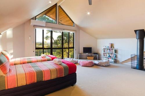 a bedroom with a bed and a large window at Bringa - Spacious Bushland Retreat with Scenic Views in Yallingup