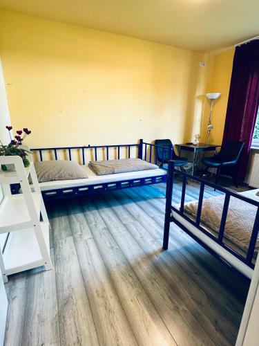 a bedroom with two bunk beds and a desk at Hostel Pinneberg in Pinneberg