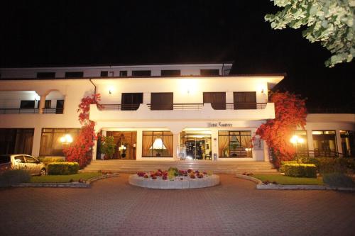 a large white building with a lot of lights at Hotel Contriz in Póvoa de Varzim