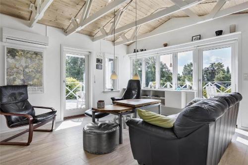 a living room with chairs and a couch and a table at 13383-Asnaes-Glentevej-15 in Asnæs