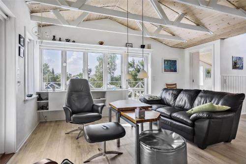 a living room with a black leather couch and chairs at 13383-Asnaes-Glentevej-15 in Asnæs