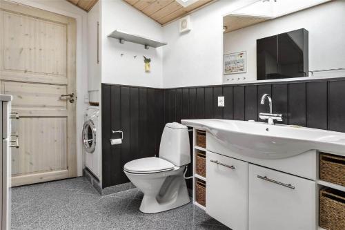a bathroom with a toilet and a sink at 13383-Asnaes-Glentevej-15 in Asnæs