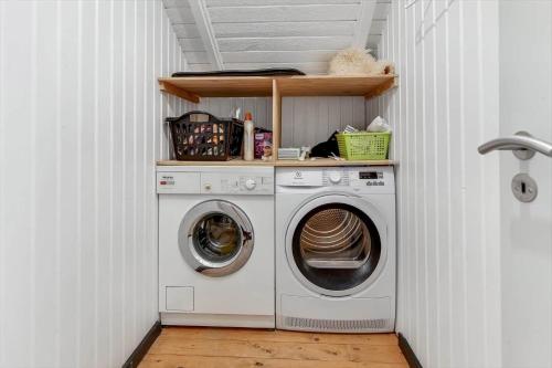 a laundry room with a washer and dryer at BV386-Blavand-Norballevej-51 in Blåvand