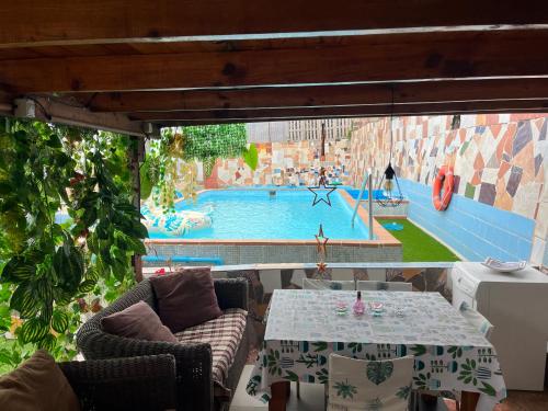 a view of a pool with a table and chairs at Apartamento torres in Santa Cruz de Tenerife